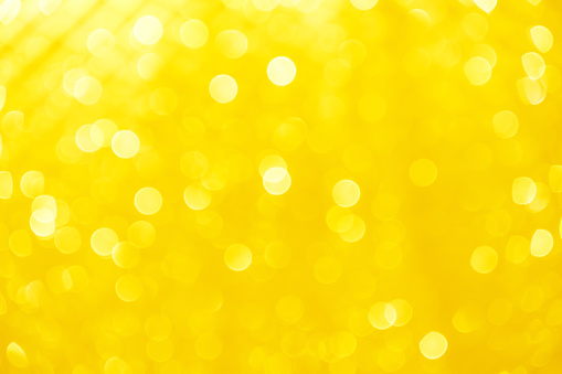 Gold yellow or light orange blurred bokeh sparkle glitter for Christmas festival or Happy new year color background
