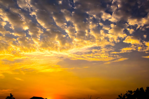 Orange sky with dark cumulus clouds.