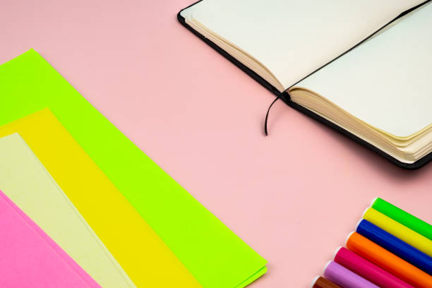 istock Back to school, with school supplies on a pink table. 1411943477