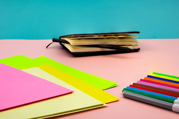 istock Back to school, with school supplies on a pink table. 1411943499