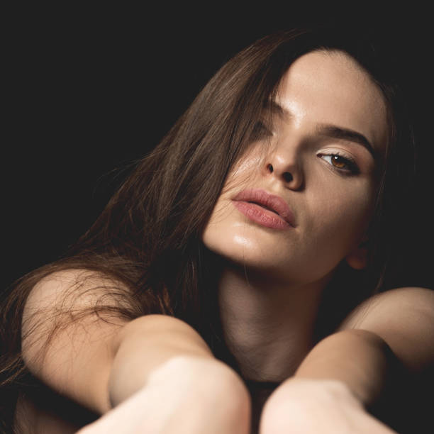 istock Sensual looking beautiful woman close-up studio portrait 1411943607