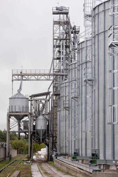 istock Galvanized steel silos for grain storage. Railway access roads for loading railway cars with grain. 1411944376