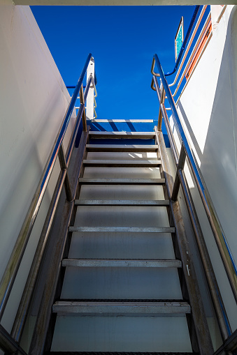 Stair on the Ship towards a clear blue sky