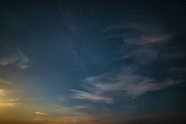 istock Stunning noctilucent cloud formations against Milky Way background night sky 1411945511