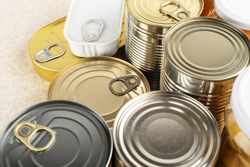 Tin cans on kitchen table background with copy space