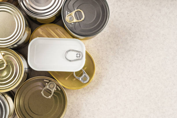 tin cans on kitchen table background with copy space flat lay - undernourishment imagens e fotografias de stock