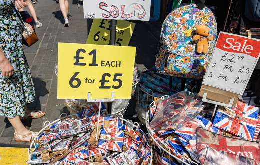 Union Jack Souvenirs For Sale on Camden High Street, London, with people and distinct patterns in the background.