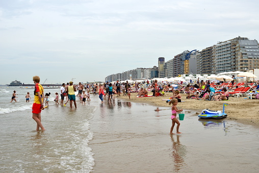 Blankenberge, West-Flanders Belgium - July 30, 2022: lifeguard supervising the sun bathers on the beach