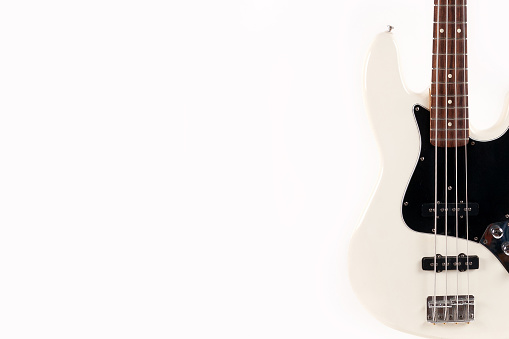 Vancouver, BC, Canada - August 31, 2012: Two maple Fender Stratocasters with focus on the nearer Guitar headstock. Photographed in black and white on a gray background.