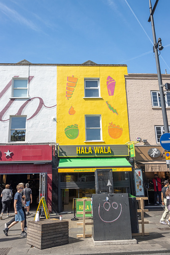 Hala Wala Restaurant on Camden High Street in Borough of Camden, London, with people visible.
