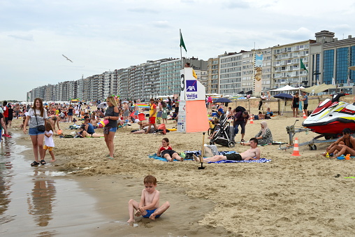 Blankenberge, West-Flanders Belgium - July 30, 2022: beach scene at height of the casino fo Blankenberge. the lifeguards have raised the green flag sign for easy swimming in the sea