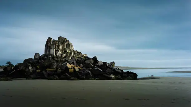 Moody image of Shag Rock, also known as Rapanui, at the entrance of the Avon Heathcote Estuary, Christchurch.