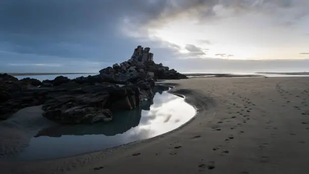 Reflection of Shag Rock, also known as Rapanui, at the entrance of the Avon Heathcote Estuary, Christchurch.
