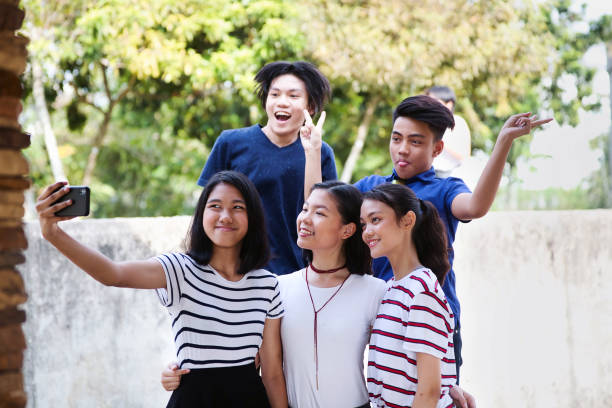 istock Group of teens taking a selfie 1411953927