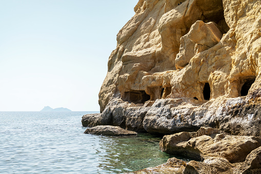 Carved caves in the rocks. Matala beach, Heraklion, Crete island, Greece. Travel vacation concept.
