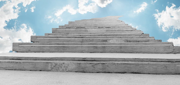 Stairs leading up to cloudy sky. Success, moving ahead, personal and professional development, career ladder concept. Path to dreams coming true. Stairway to heaven. High quality photo