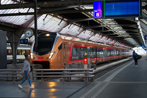 Golden SOB train named Voralpen Express at main railway station at Zürich City on an early sunny summer morning. Photo taken June 25th, 2022, Zurich, Switzerland.