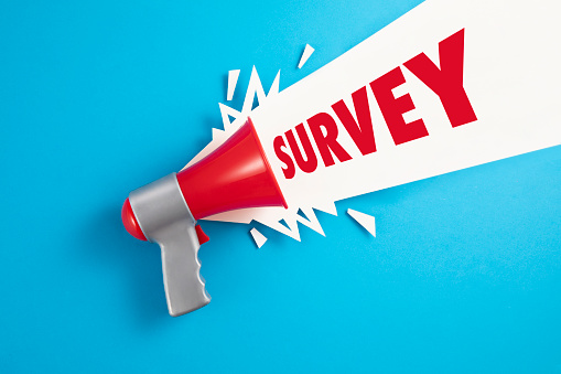 Red Megaphone with the text Survey on blue background