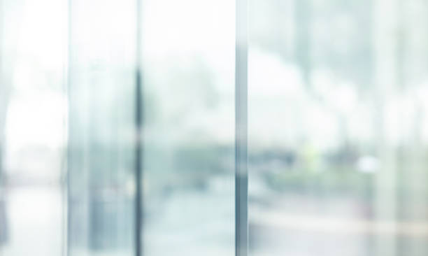 blurred images of glass wall with city town background.modern abstract window - binnenopname fotos stockfoto's en -beelden