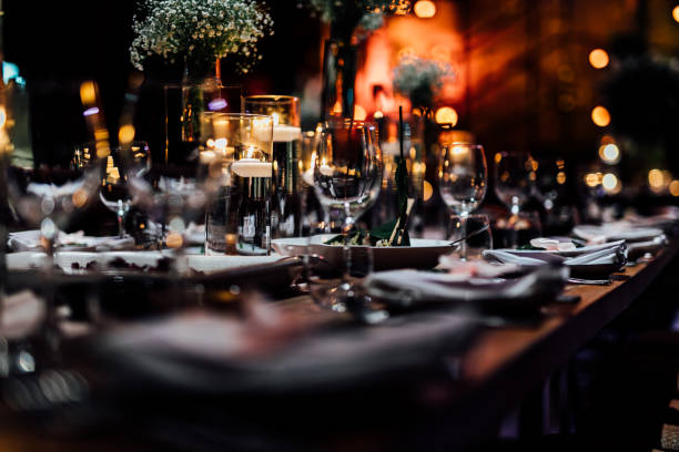 Wine and champain glass in luxury weddings and events. Luxury table settings for fine dining with and glassware, pouring wine to glass. Beautiful blurred background. Preparation for holiday wedding. Fancy luxury restaurant. restaurant stock pictures, royalty-free photos & images