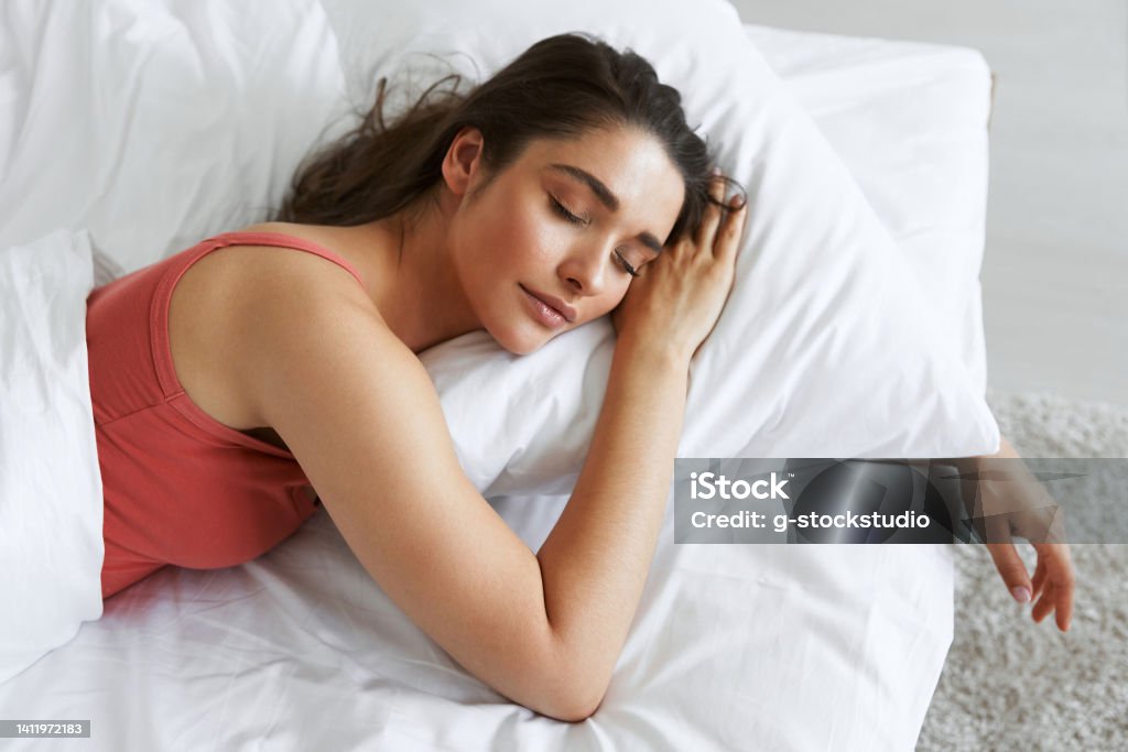 Top view of beautiful young woman sleeping while lying in bed Sleeping Stock Photo