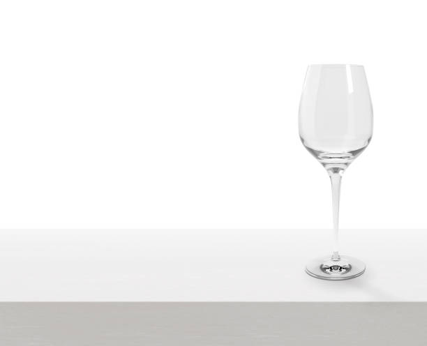 istock Empty wine glass on white wooden table with copy space 1411972265