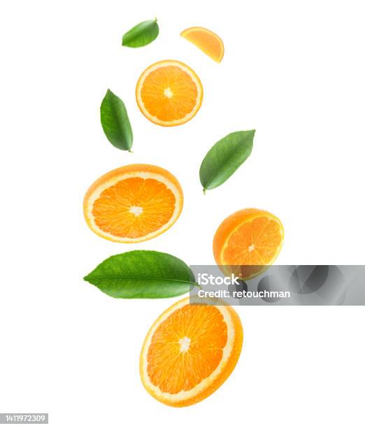 Falling Juicy Oranges With Green Leaves Isolated On Transparent Background Flying Defocusing Slices Of Oranges Applicable For Fruit Juice Advertising Stock Photo - Download Image Now