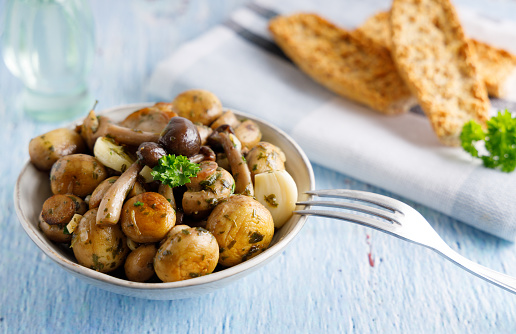 Mushrooms prepared with garlic , fresh butter and parsley served as a appetizer.