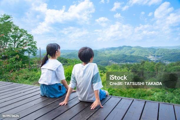 山頂からの眺めを眺める日本の小学生