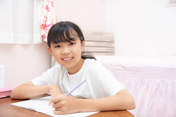 istock Elementary school girl studying in a child's room 1411973752