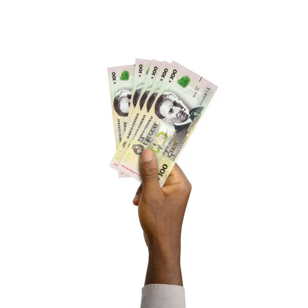 istock Black Hand holding 3D rendered 100 Peso Uruguayo notes isolated on white background 1411974579