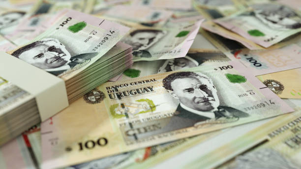 istock 100 Uruguayan Peso Uruguayo notes spread out  with a calculator, pen and notebook. 3d rendering 1411974631