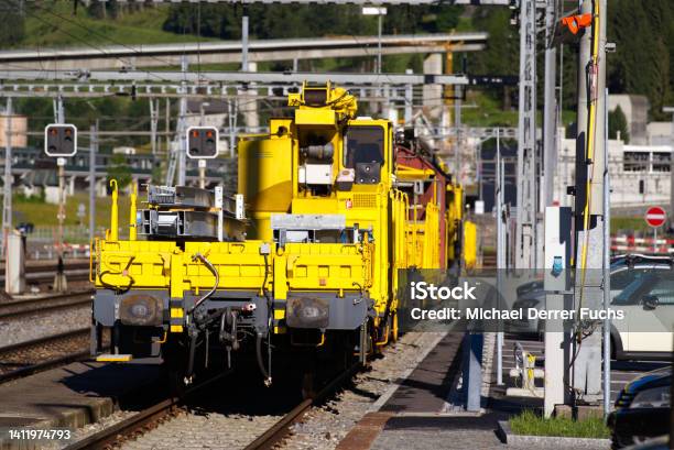 Railway Station Airolo Canton Ticino With Railway Tracks And Yellow Construction Train On A Sunny Summer Day Stock Photo - Download Image Now