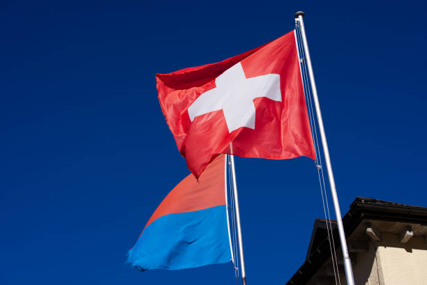 Swiss flag and flag of Canton Ticino waving at famous Swiss mountain pass St. Gotthard on a sunny summer day. Photo taken June 25th, 2022, Gotthard Pass, Switzerland. gotthard pass stock pictures, royalty-free photos & images