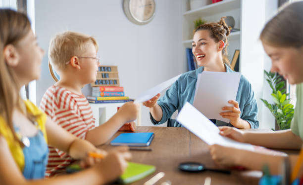 istock Happy kids and teacher at school 1411977304