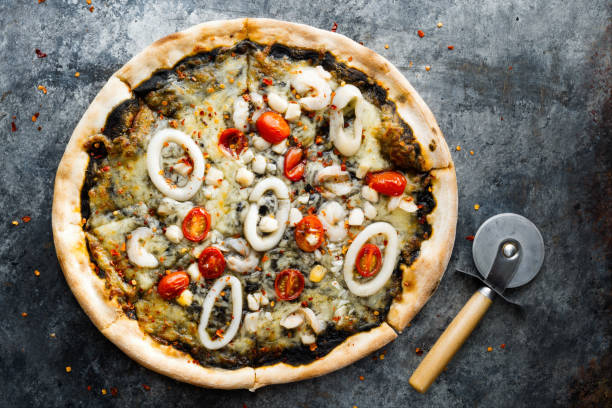 istock rustic italian squid ink black seafood pizza 1411980413
