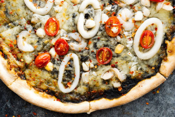 istock rustic italian squid ink black seafood pizza 1411980416