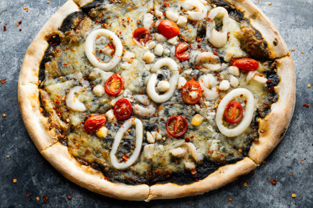 istock rustic italian squid ink black seafood pizza 1411980421
