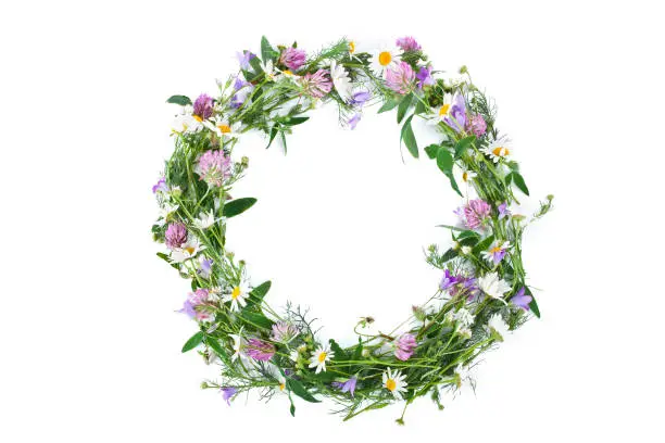 Beautiful wreath with colorful flowers isolated on a white background. Midsummer celebration concept, summer decoration. Top view.