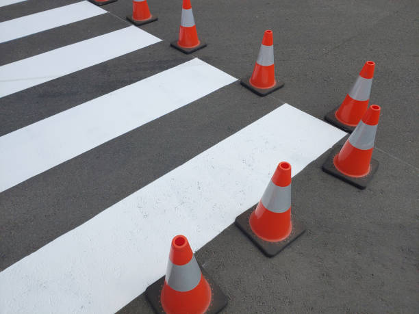 istock Fresh painted pedestrian crossing on asphalt marked with traffic cones. 1411987134