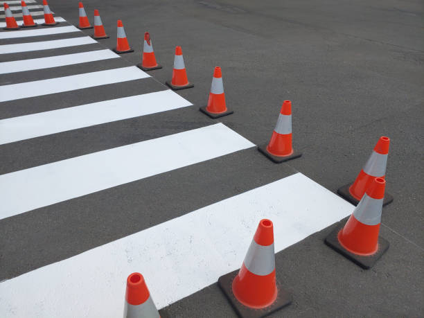 istock Fresh painted pedestrian crossing on asphalt marked with traffic cones. 1411987143