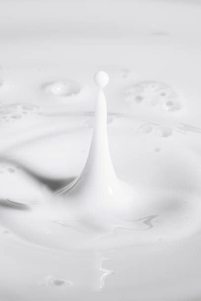 istock Macro milk drop,milk drops with ripples, Pouring milk 1411987921