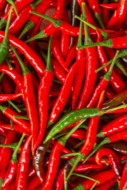 istock macro red chili,Red chili pepper background,Red hot chili peppers pattern Chili texture background. Close up landscape background of hot chili peppers. Roadside vegetable market. Red chili group. 1411988572