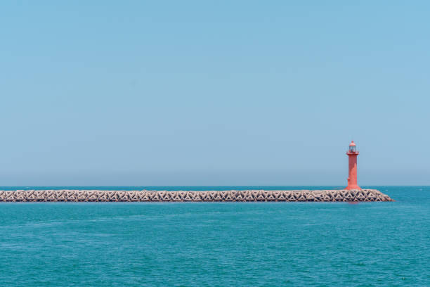 The summer sea and the red lighthouse