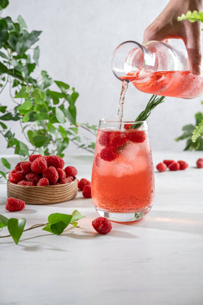istock Summer refreshing non-alcoholic cocktails. Raspberry lemonade garnished with fresh rosemary. Summer raspberry beverage with sparkling water. Copy space. 1411989644