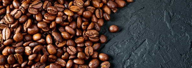 istock Roasted coffee beans on a black background. Copy space. Flat lay. Banner 1411991329