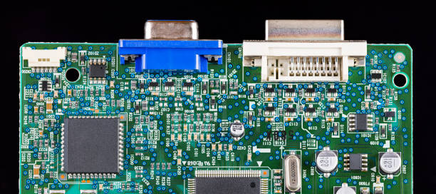 istock Green printed circuit board detail isolated on a black panoramic background 1411991473