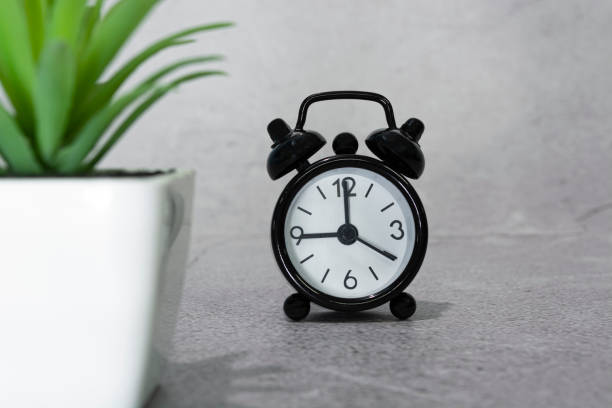 istock Black alarm clock isolated. The clock set at 9 o'clock. Deadline concept. 1411991700