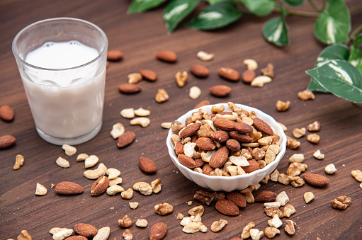 Mixed nuts and almond milk in a wooden bowl