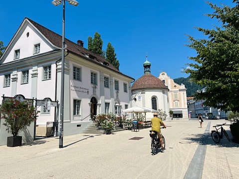 Bregenz, Austria - July, 24 - 2022: Street in the center of the city. Biker in the foreground.